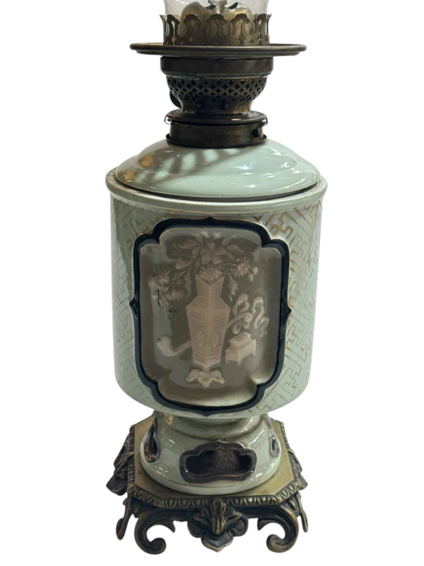 Chinese Celadon oil lamp with floral panel decoration on gilt metal base.