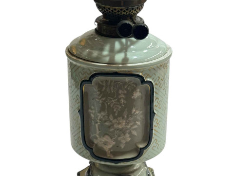 Chinese Celadon oil lamp with floral panel decoration on gilt metal base.