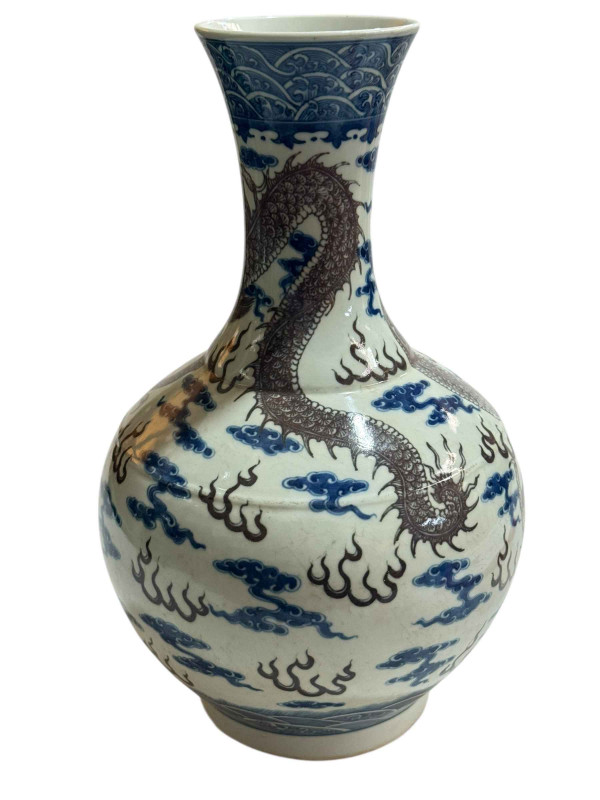 Large Chinese pottery vase decorated with dragon design on blue and white ground, 38cm.