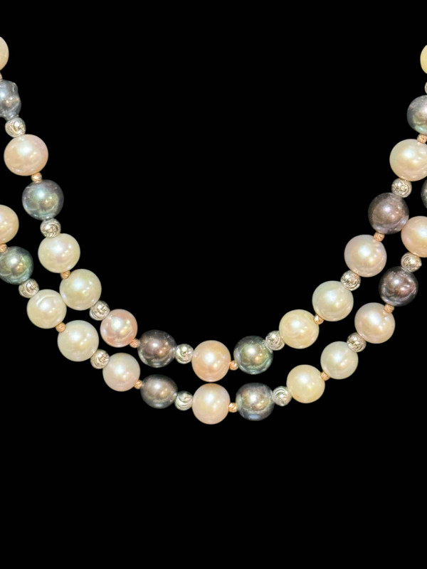 Long strand of black, white and silver pearls, total length approximately 90cm.