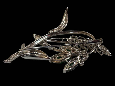 An 18 carat white gold, green jade and diamond set brooch, design as a foliate spray with marquise cut jade and round cut diamonds. thumbnail