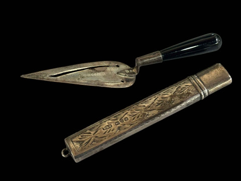 Silver pencil holder and small sterling silver trowel with ebonised handle.