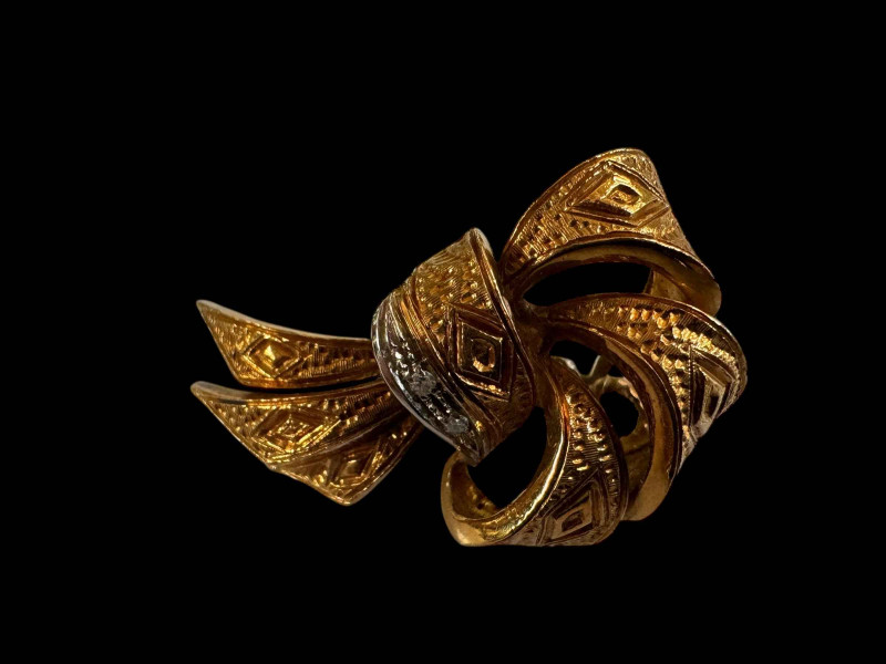 Pair of 18 carat gold ribbon design earrings with small two diamond decorative row and white gold clip fastenings.