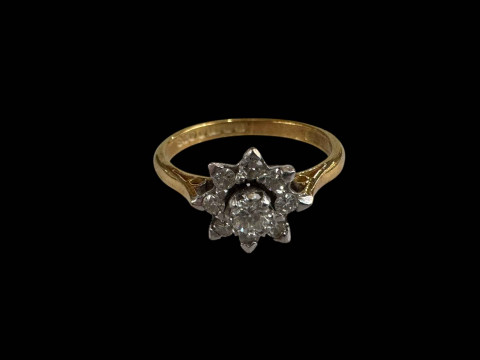 18 carat yellow gold petal design nine stone diamond ring, size K.