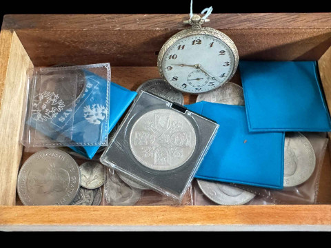 Box of assorted coins and pocket watch.