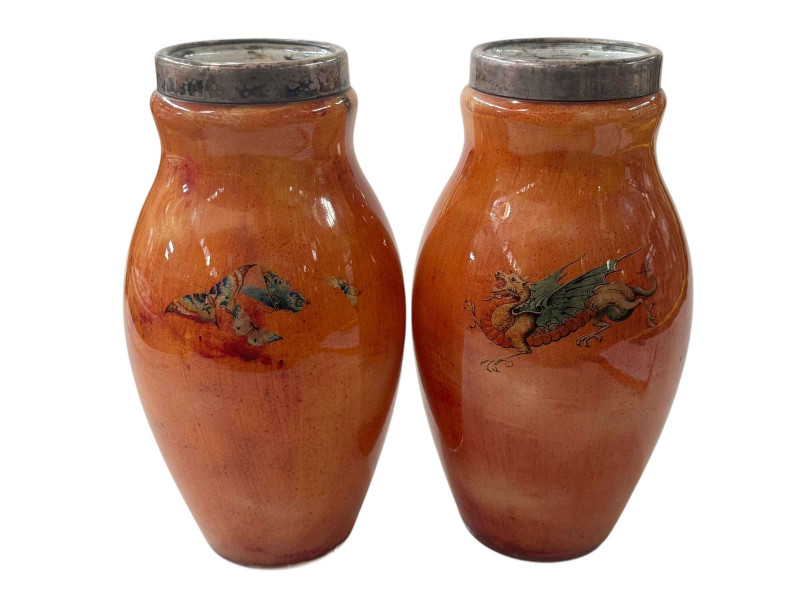 Pair of Stourbridge DG orange glass vases with dragon and butterfly decoration and metal mounted tops, 27cm.