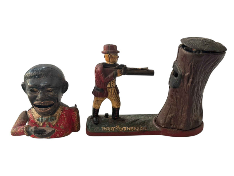 Two cast metal novelty money boxes.