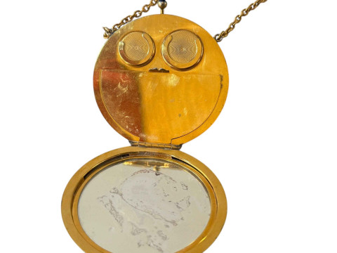 Gilt metal and enamel decorated sovereign case in the form of a ladies compact. thumbnail