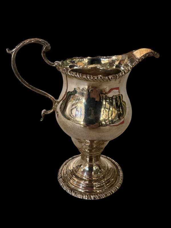 George III silver helmet cream jug having gadroon borders, London 1767, 12cm.