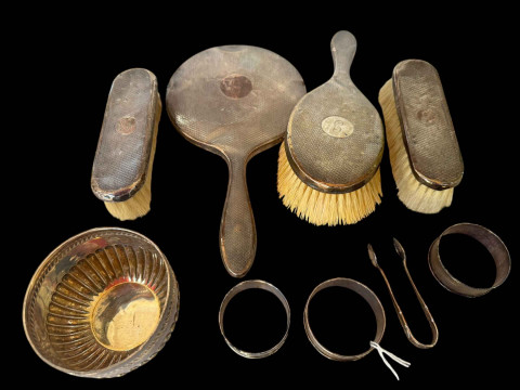 Silver four piece brush and mirror set, three napkin rings, tongs and...