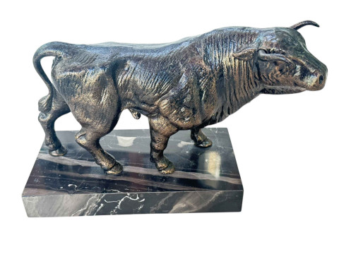 Bronzed Bull on marble plinth.