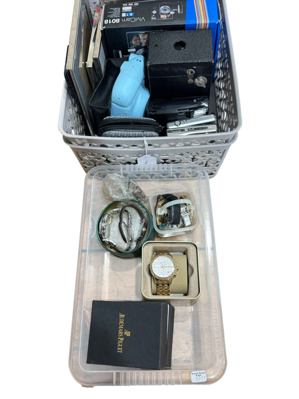 Two boxes with watches, cameras and photograph frames.