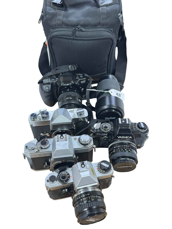Minolta Dynax 500 camera with bag and four vintage Yashica cameras.