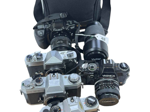 Minolta Dynax 500 camera with bag and four vintage Yashica cameras.