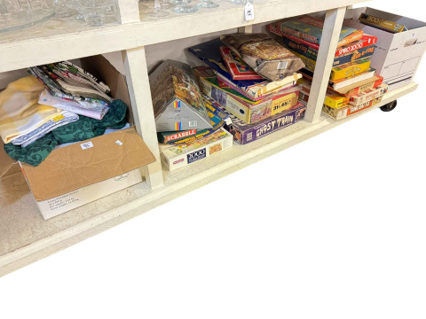 Collection of vintage games, jigsaws and box of table linen.