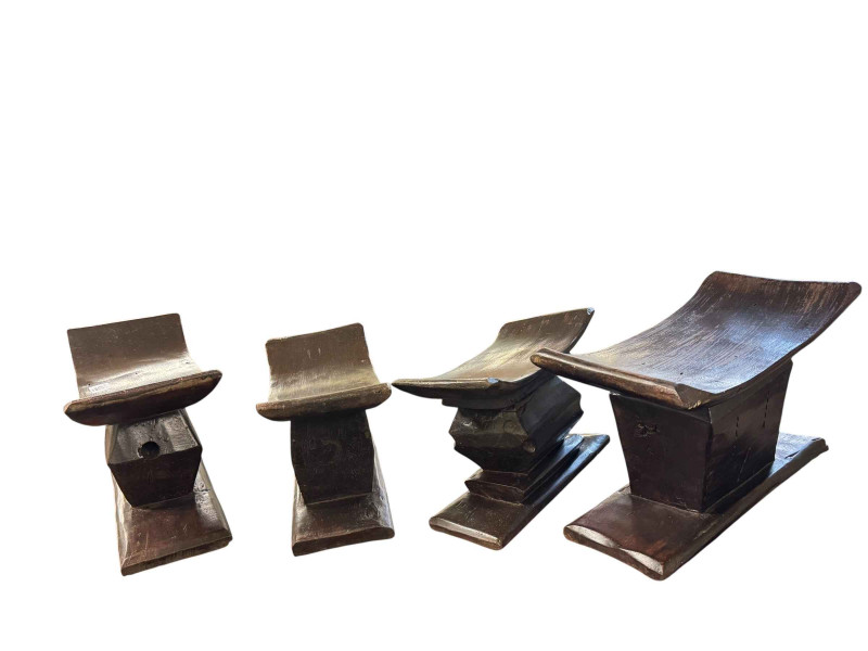 Four Indian wooden head rests.