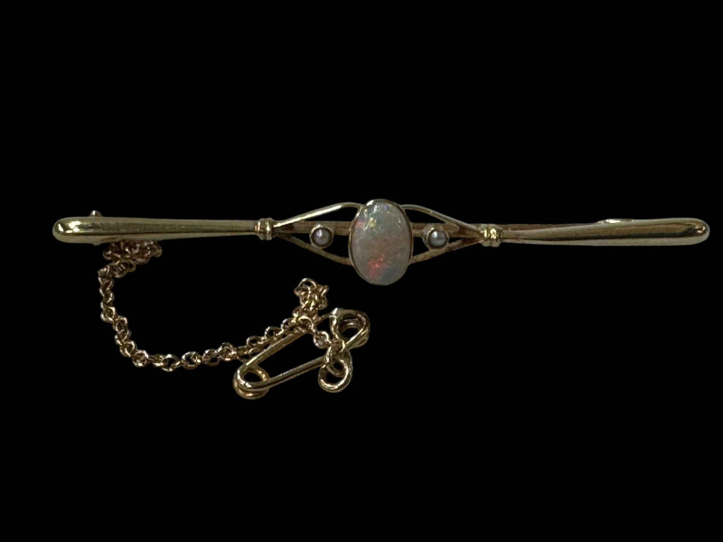 Opal and seed pearl 15 carat gold bar brooch with safety chain, 5.7cm across.