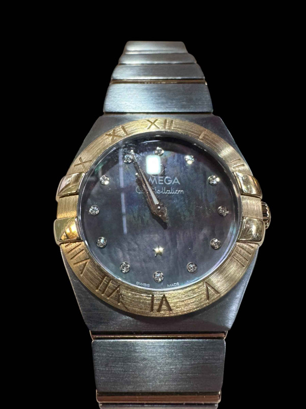 Good ladies Omega Constellation quartz watch in stainless steel and 18 carat yellow gold with mother of pearl diamond set dial, in little used condition and with box, papers and travel case, serviced in 2021 at a cost of £450.