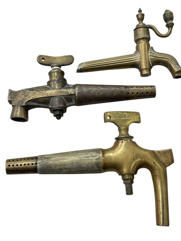 Three brass barrel taps.