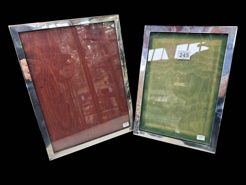 Two silver mounted rectangular easel photograph frames.