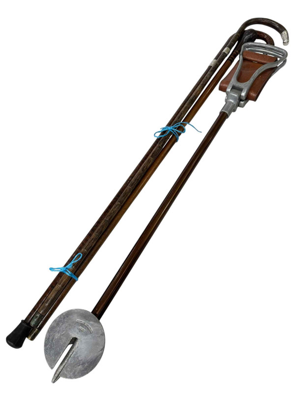 Three walking sticks including two silver mounted together with a shooting stick.