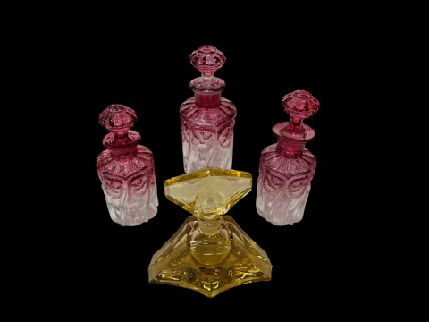 Set of three Baccarat rose tint perfume bottles with a French art deco...