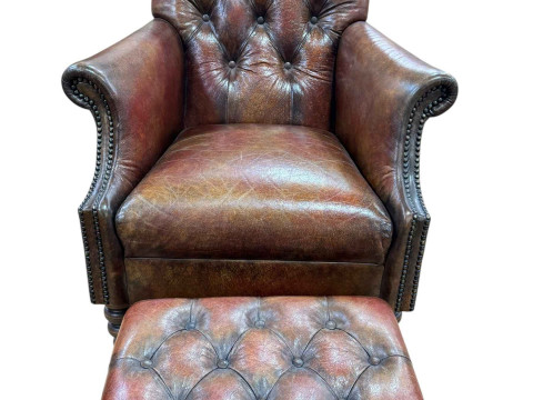 Tetrad brown buttoned leather and studded armchair and footstool.