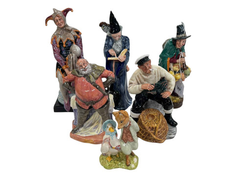 Five Royal Doulton figures The Jester, The Mask Seller, The Wizard, The...