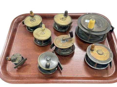 Collection of eight vintage fishing reels.