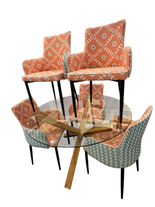 Contemporary circular glass topped X-framed tables and five chairs.