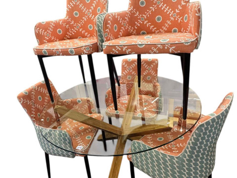 Contemporary circular glass topped X-framed tables and five chairs.