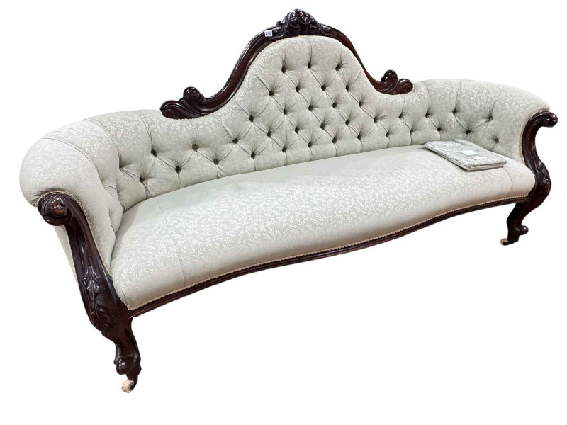 Victorian mahogany framed arched back settee in buttoned fabric with serpentine front seat.