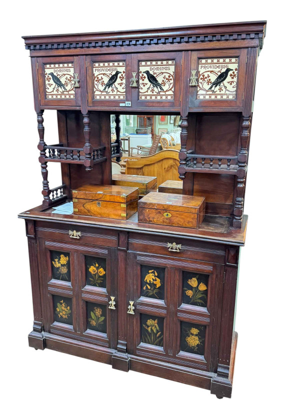 Late Victorian aesthetic mirror backed cabinet having four canopy doors with Minton panels with raven decoration, the base with floral painted panel doors, 198cm by 132cm by 48cm.