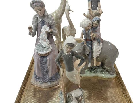 Four Lladro figures, Hindu Elephant and children and Lady Sewing a Trousseau,...