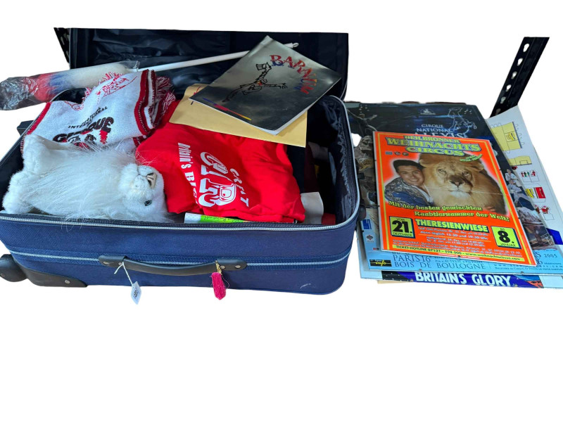 Eight boxes and two suitcases of circus related ephemera, badges and collectables.