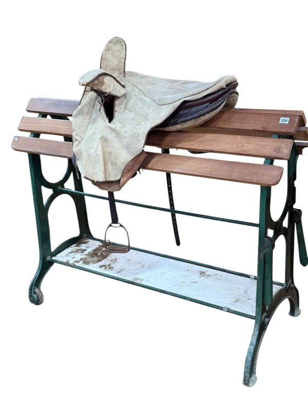 Victorian Musgrave patent cast iron and wood slat saddle stand and leather saddle.