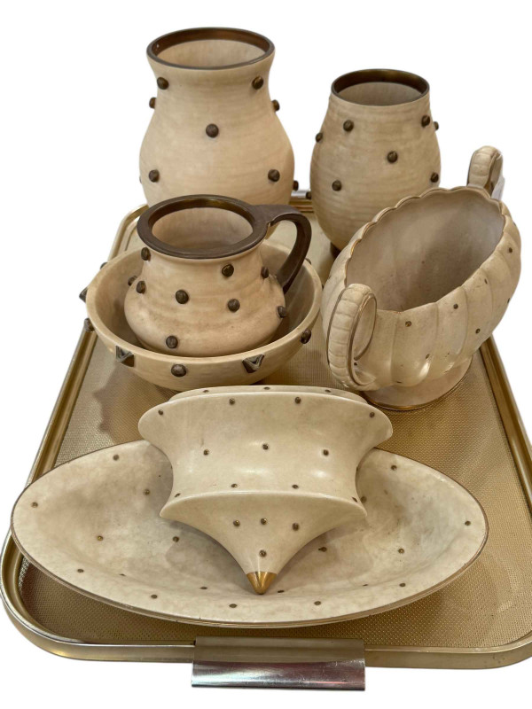 Seven pieces of Bursley Ware Charlotte Rhead Polka Dot pottery including two vases, jug, bowl and planter.