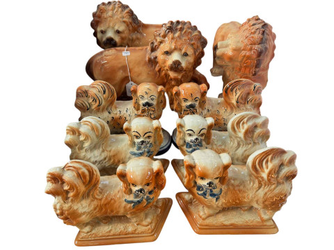 Three large Staffordshire fireside lions and six Staffordshire Pekinese...
