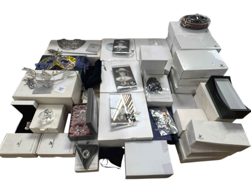 Collection of boxed Swarovski including three masks, photograph frames, ornaments and various stands.