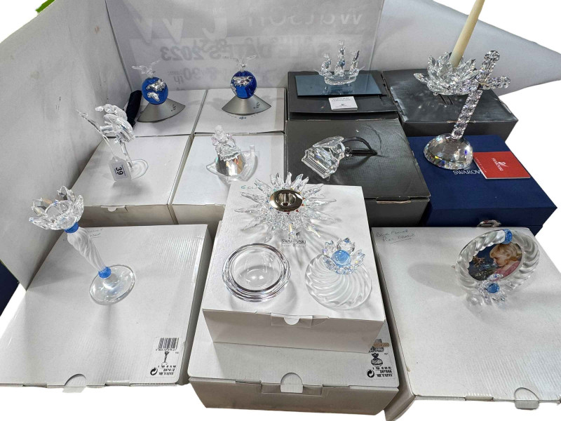 Collection of boxed Swarovski candle holders, cross, figures, two planets, etc.