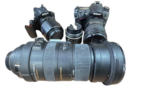 Collection of camera equipment including Nikon D7000 digital camera, Sigma F500mm lens, Nikon D90 camera, lenses and accessories, Celestron telescope, binoculars, monoscope, Staunton chess set, etc. thumbnail
