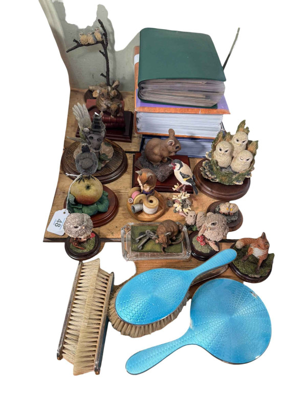 Five piece silver and enamel backed brush and mirror set, animal ornaments, three albums of postcards.