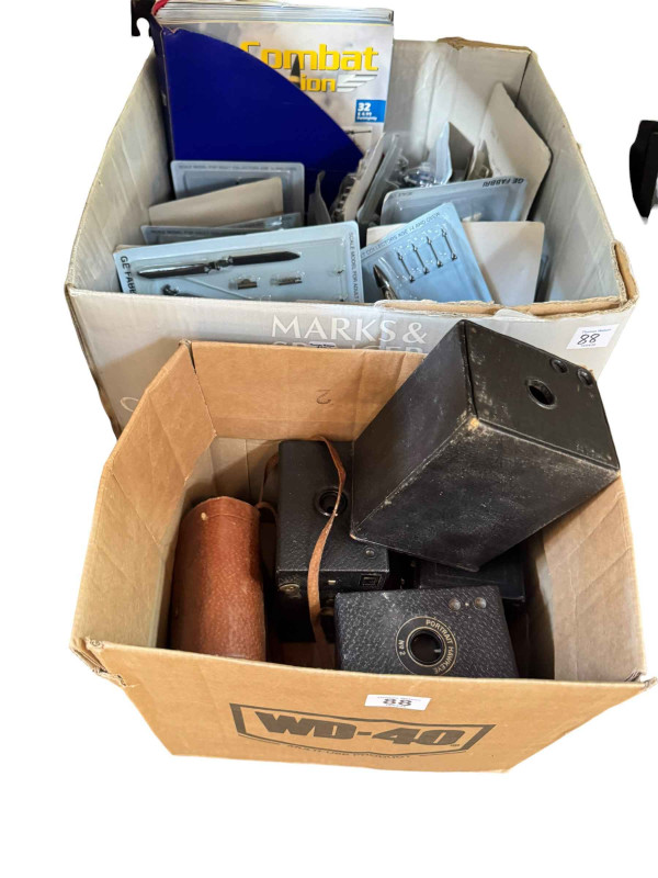 Collection of Air Combat fighter jet models with magazines, four box cameras, pair of binoculars and hunting scene painting.