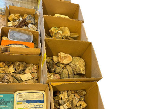 Large collection of mineral stones in boxes and display cases.