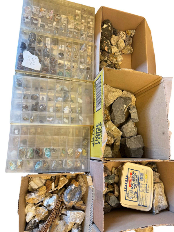 Large collection of mineral stones in boxes and display cases.
