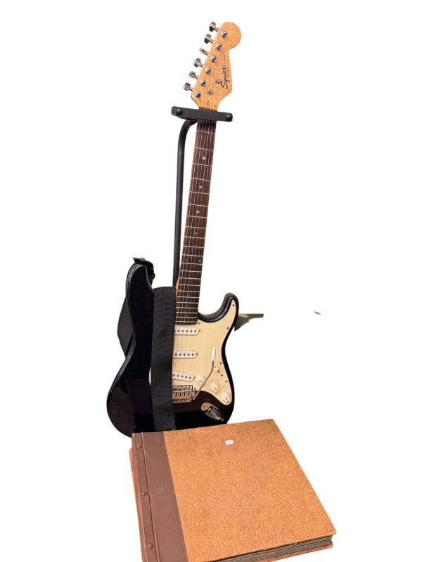 Electric guitar, Squier sp10 amp and two albums of 78rpm records.