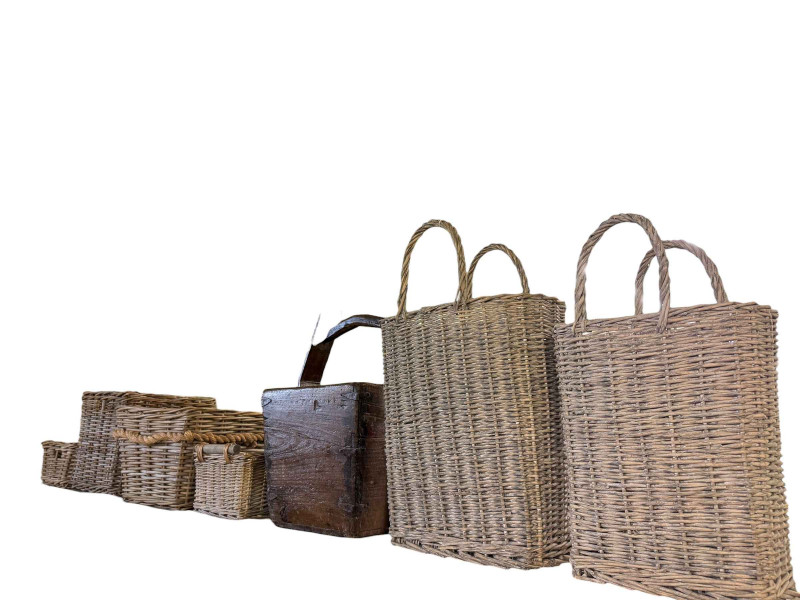 Wooden pail and collection of wicker baskets.