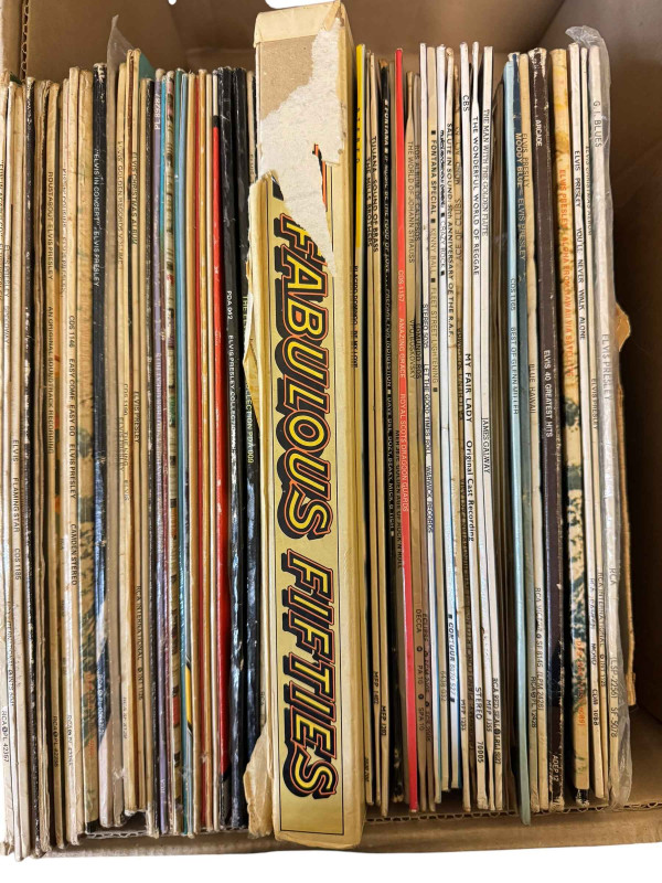 Two boxes of LP records and single records including many Elvis LP's.