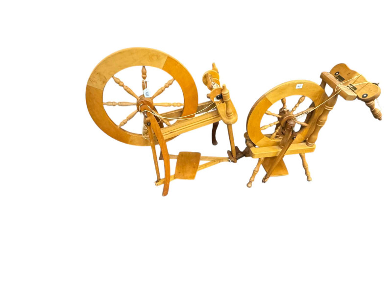 Two wooden spinning wheels and a case of accessories.