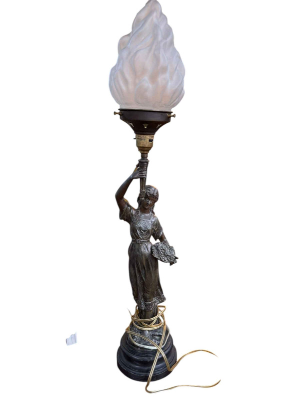 A spelter figure newel post lamp with frosted glass shade, 68cm high.